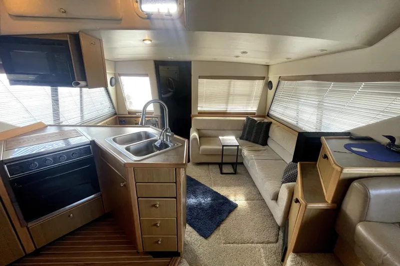 Slide: The Image of Interior of 2001 Bayliner 3988 Command Bridge Motoryacht with kitchen and seating area. - 15
