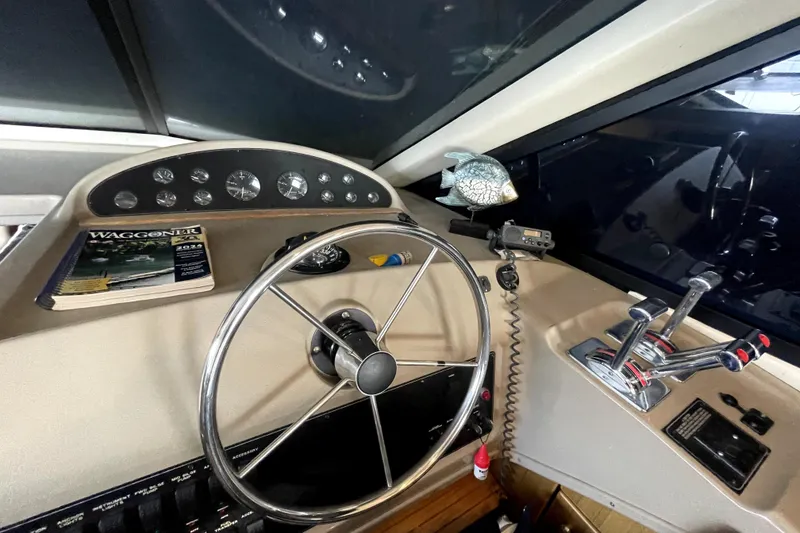 Slide: The Image of 2001 Bayliner 3988 Command Bridge Motoryacht helm with steering wheel and controls. - 17