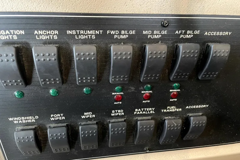 Slide: The Image of Control panel of a 2001 Bayliner 3988 Command Bridge Motoryacht with labeled switches. - 20