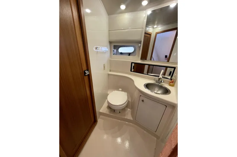Slide: The Image of 2001 Bayliner 3988 Command Bridge Motoryacht bathroom with sink, toilet, and mirror. - 24