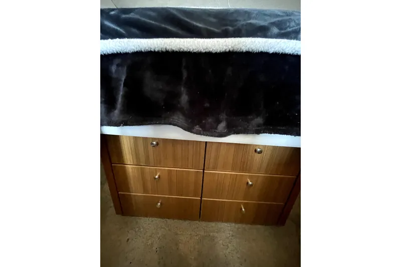 Slide: The Image of Wooden drawers with a dark blanket, Bayliner 3988 Command Bridge Motoryacht, 2001 interior. - 28