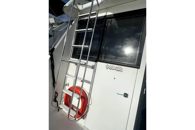 Slide: The Image of 2001 Bayliner 3988 Command Bridge Motoryacht with ladder and life preserver. - 3