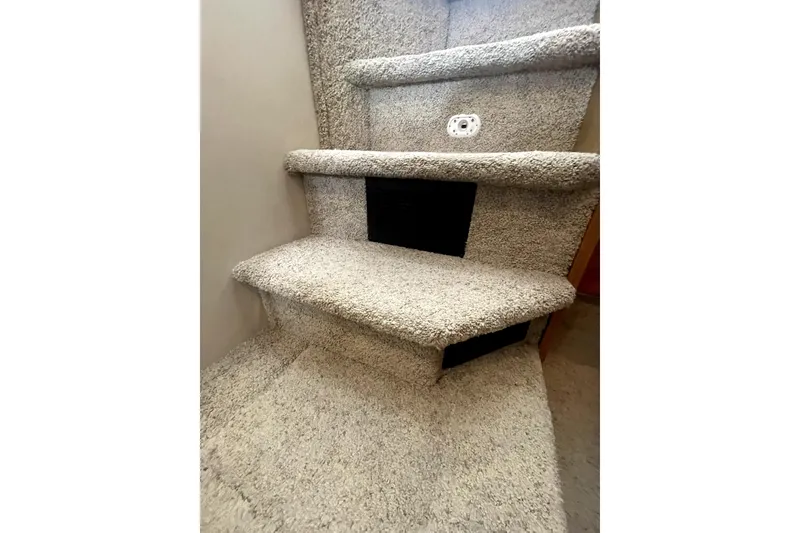 Slide: The Image of Carpeted stairs inside 2001 Bayliner 3988 Command Bridge Motoryacht, featuring beige carpeting. - 34