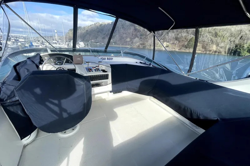 Slide: The Image of 2001 Bayliner 3988 Command Bridge Motoryacht interior with covered seating and steering wheel. - 35