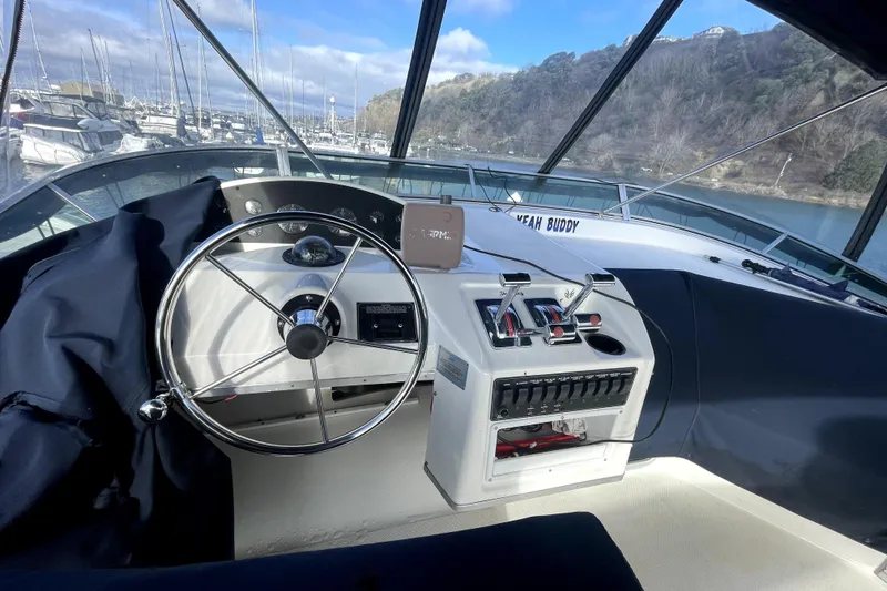 Slide: The Image of 2001 Bayliner 3988 Command Bridge Motoryacht helm with steering wheel and control panel. - 36
