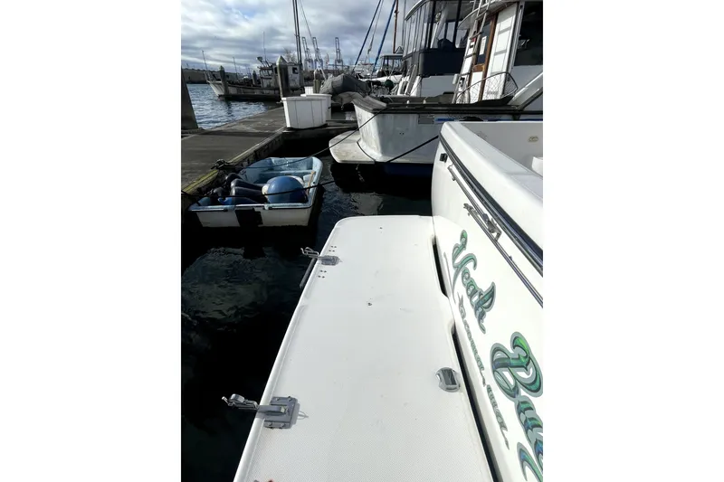 Slide: The Image of 2001 Bayliner 3988 Command Bridge Motoryacht docked at marina with small boat nearby. - 4