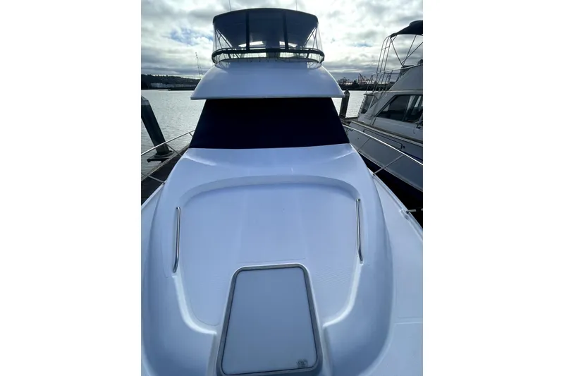Slide: The Image of 2001 Bayliner 3988 Command Bridge Motoryacht docked, showcasing sleek design and spacious deck. - 40
