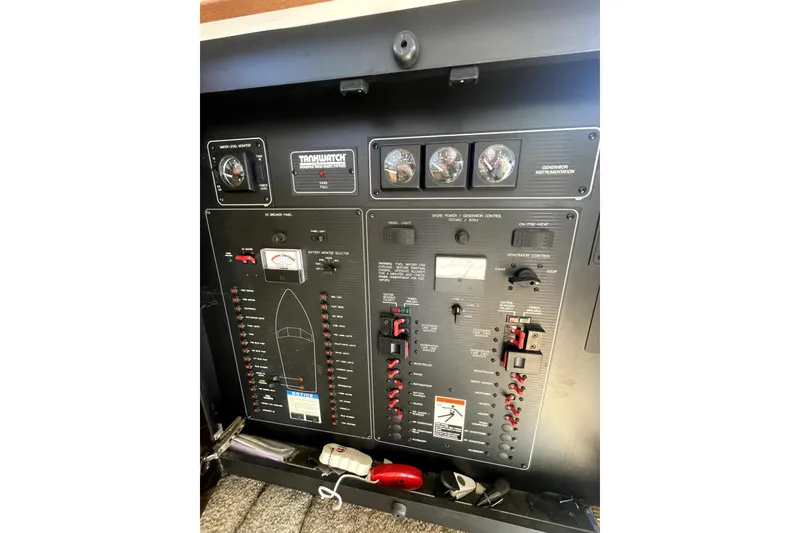 Slide: The Image of Control panel of a 2001 Bayliner 3988 Command Bridge Motoryacht, featuring gauges and switches. - 42