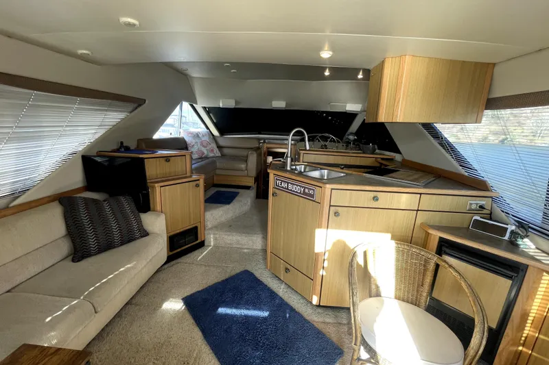 Slide: The Image of Interior of 2001 Bayliner 3988 Command Bridge Motoryacht with cozy seating and modern kitchen. - 6