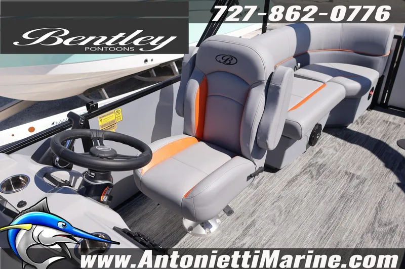 Slide: The Image of 2026 Bentley Pontoons Bolt 223 interior with gray and orange seating, steering wheel, and flooring. - 21