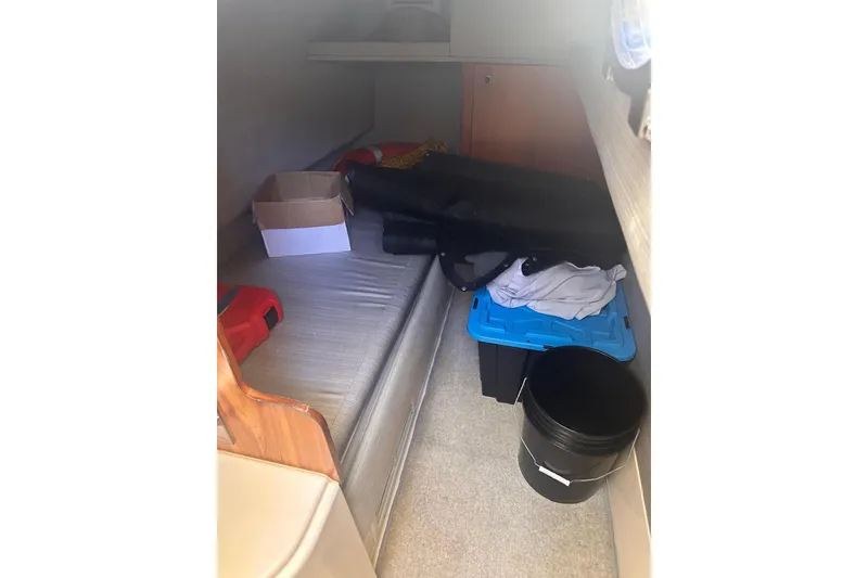 Slide: The Image of 2007 Azimut 55E yacht interior cabin with storage items and seating area. - 16