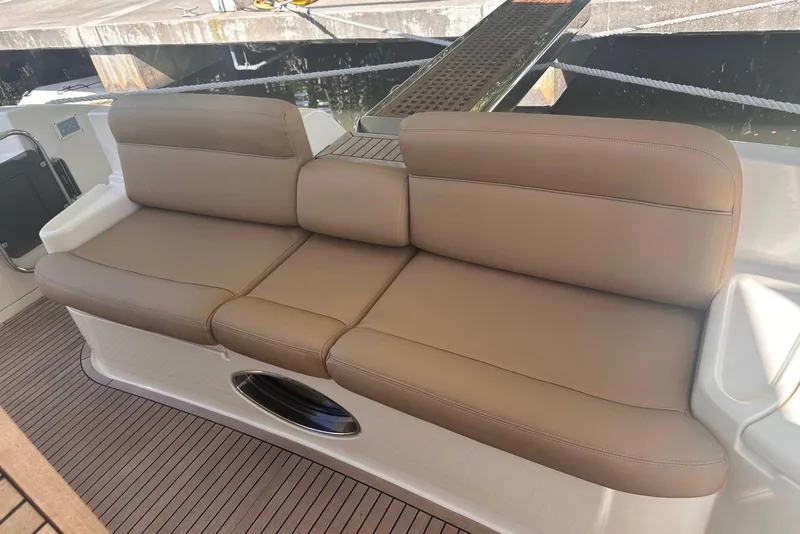 Slide: The Image of Luxurious seating on 2007 Azimut 55E yacht, featuring beige leather upholstery. - 17