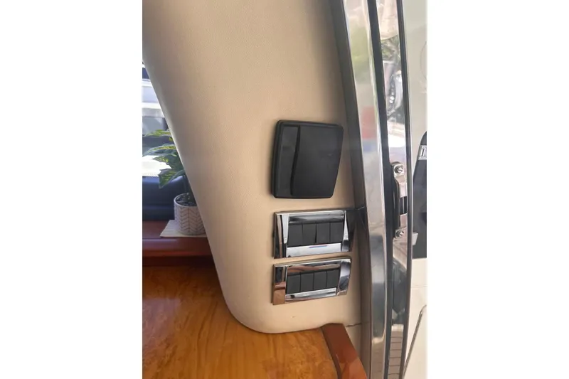 Slide: The Image of Interior controls of a 2007 Azimut 55E yacht, featuring sleek switches and wood accents. - 20