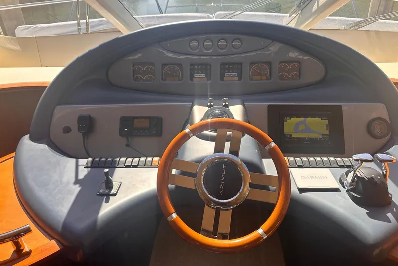 Slide: The Image of Steering wheel and dashboard of a 2007 Azimut 55E yacht with navigation equipment. - 21