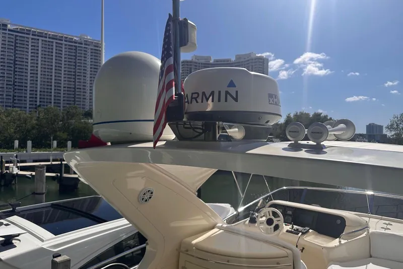 Slide: The Image of 2007 Azimut 55E yacht with Garmin radar, docked under clear blue sky. - 30