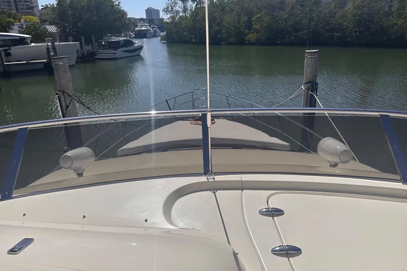 Slide: The Image of 2007 Azimut 55E yacht docked in a serene marina setting. - 31