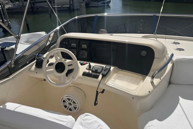 Slide: The Image of 2007 Azimut 55E yacht helm with steering wheel and control panel. - 32
