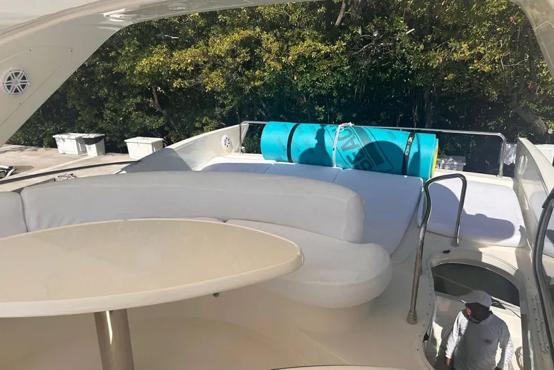 Slide: The Image of Luxurious 2007 Azimut 55E yacht deck with seating and table, surrounded by greenery. - 33