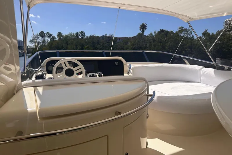 Slide: The Image of 2007 Azimut 55E yacht helm with luxurious seating and scenic view. - 36