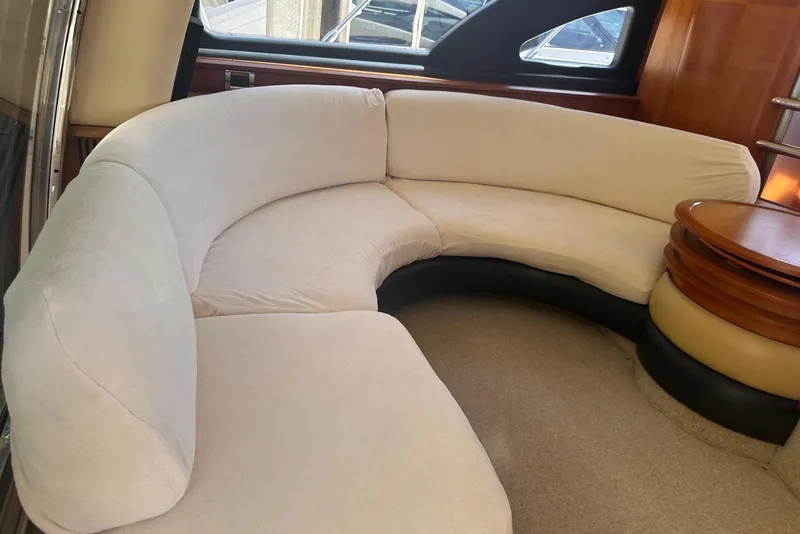 Slide: The Image of Luxurious interior of 2007 Azimut 55E yacht with curved beige seating. - 38