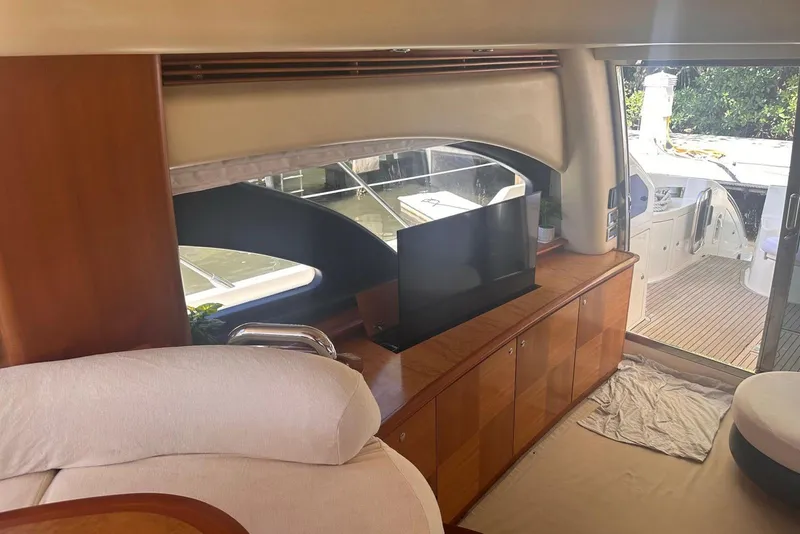 Slide: The Image of Interior of 2007 Azimut 55E yacht with TV, wooden cabinets, and sliding glass door. - 47