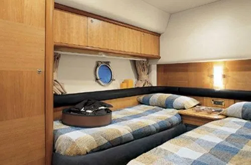 Slide: The Image of 2007 Azimut 55E yacht cruising on a serene waterway with lush greenery. - 6