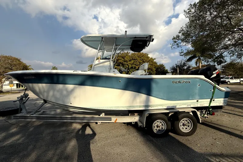 Slide: The Image of 2008 Sea Fox 256 Center Console boat on trailer under cloudy sky. - 11