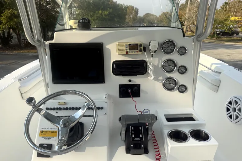 Slide: The Image of 2008 Sea Fox 256 Center Console boat dashboard with steering wheel, gauges, and controls. - 7