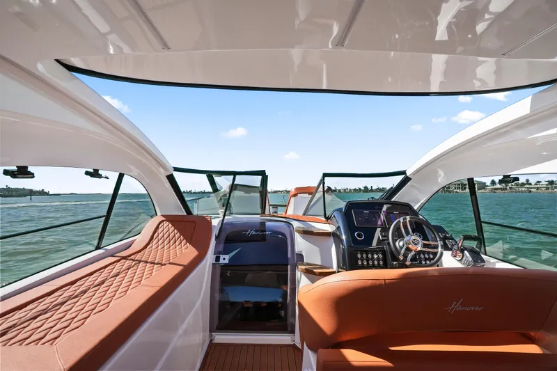 Slide: The Image of Interior view of 2026 Hanover 355 boat with luxurious seating and modern dashboard. - 13