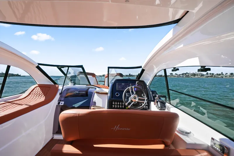Slide: The Image of Interior view of 2026 Hanover 355 yacht with luxurious seating and modern dashboard. - 20
