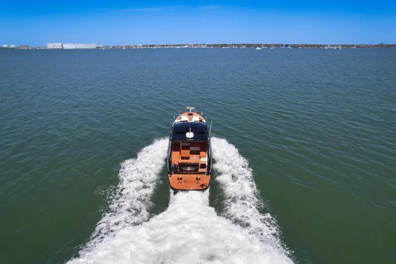 Slide: The Image of 2026 Hanover 355 boat cruising on open water under clear blue sky. - 6