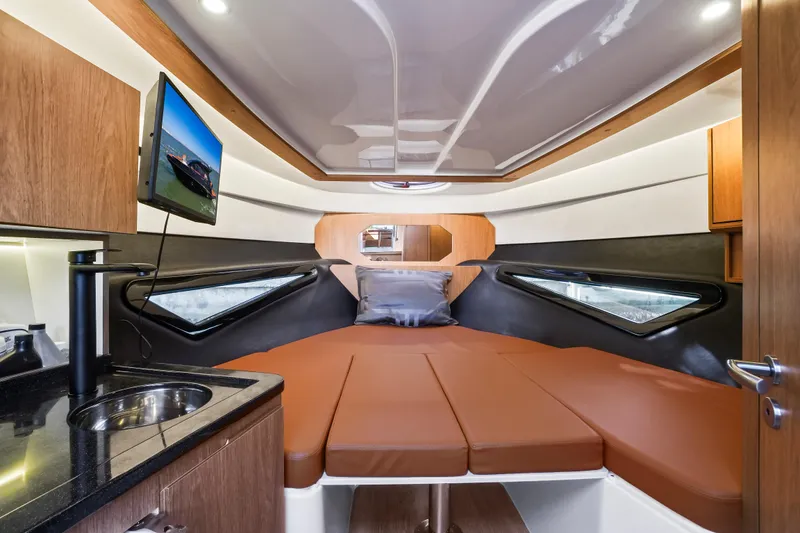 Slide: The Image of Luxurious interior of 2026 Hanover 355 boat with bed, TV, and kitchenette. - 7
