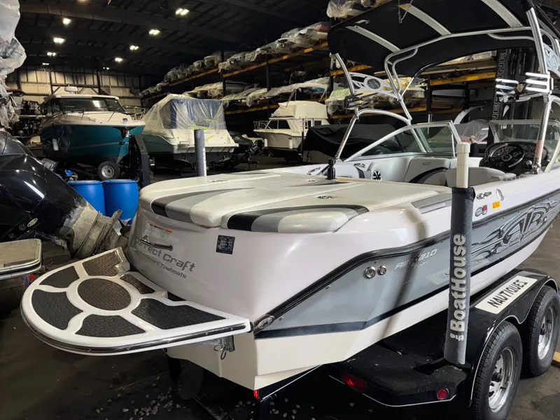 Slide: The Image of 2006 Correct Craft Air Nautique 210 boat in storage facility. - 1