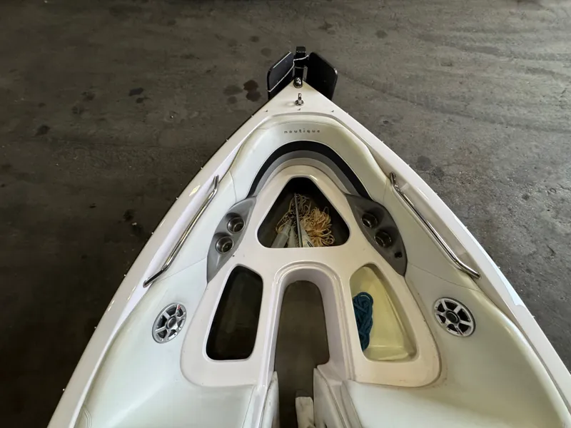 Slide: The Image of Bow of a 2006 Correct Craft Air Nautique 210 boat with storage. - 23