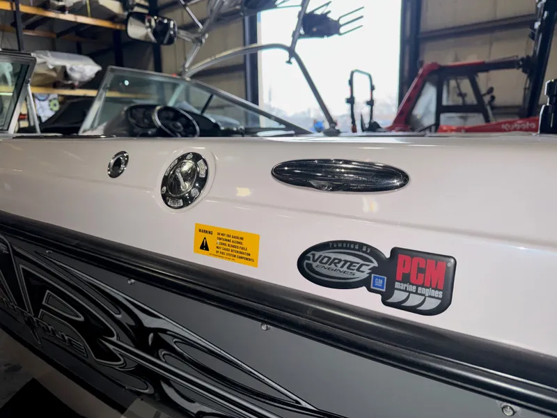 Slide: The Image of 2006 Correct Craft Air Nautique 210 boat interior with engine stickers. - 42