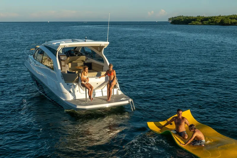 Slide: The Image of Luxury Hanover 375 yacht, 2026 model, with people enjoying water activities in the ocean. - 103