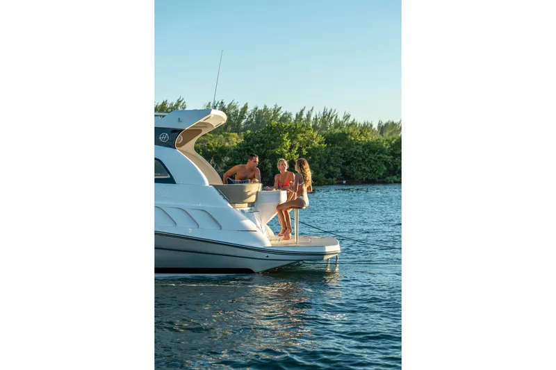 Slide: The Image of People enjoying leisure time on a 2026 Hanover 375 yacht by the water. - 108