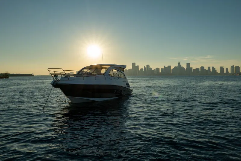 Slide: The Image of Luxury Hanover 375 yacht on water at sunset, city skyline in background, 2026 model. - 110