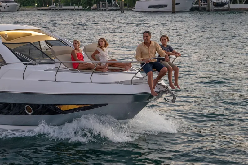 Slide: The Image of Family enjoying a ride on a 2026 Hanover 375 yacht in open water. - 118