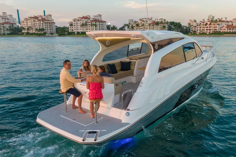 Slide: The Image of Luxury Hanover 375 yacht cruising with passengers, 2026 model, near waterfront buildings. - 13