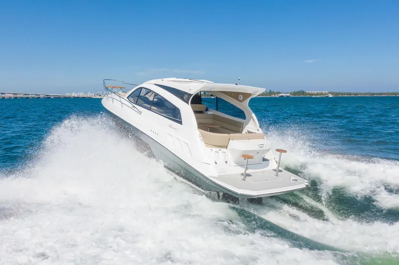 Slide: The Image of 2026 Hanover 375 yacht cruising on open water, creating waves under clear blue sky. - 15