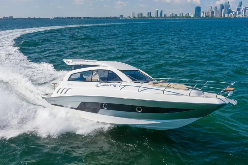 Slide: The Image of 2026 Hanover 375 yacht cruising on open water with city skyline in background. - 20