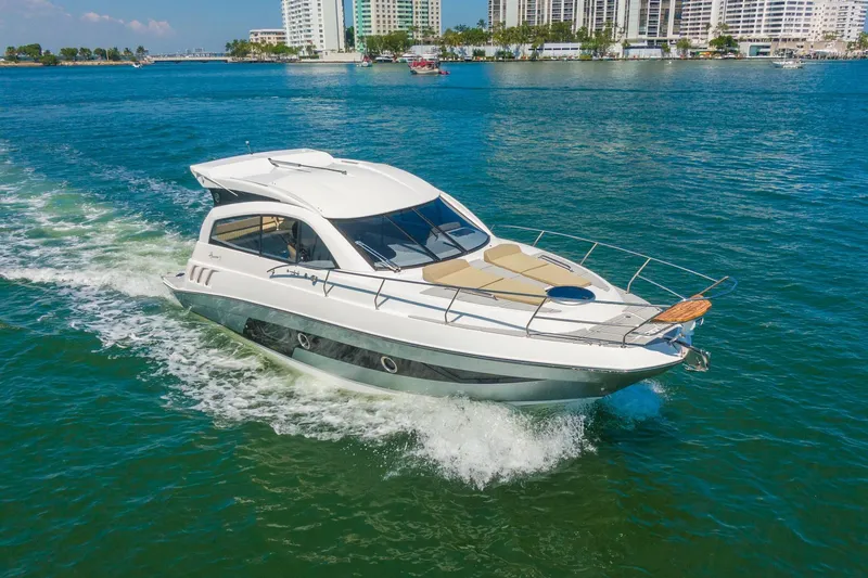 Slide: The Image of 2026 Hanover 375 yacht cruising on blue water near city skyline. - 26