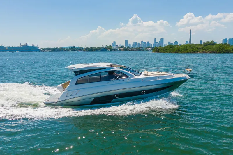 Slide: The Image of 2026 Hanover 375 yacht cruising on blue water with city skyline in background. - 31
