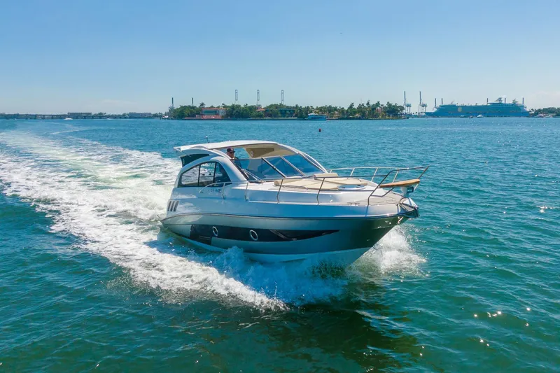 Slide: The Image of 2026 Hanover 375 yacht cruising on open water under clear blue skies. - 32