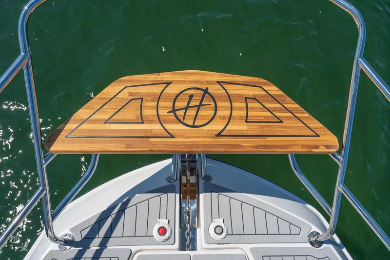 Slide: The Image of Bow view of 2026 Hanover 375 boat with teak deck and stainless steel railings. - 64
