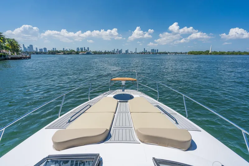 Slide: The Image of Luxury Hanover 375 yacht cruising on a sunny day, city skyline in the background. - 68