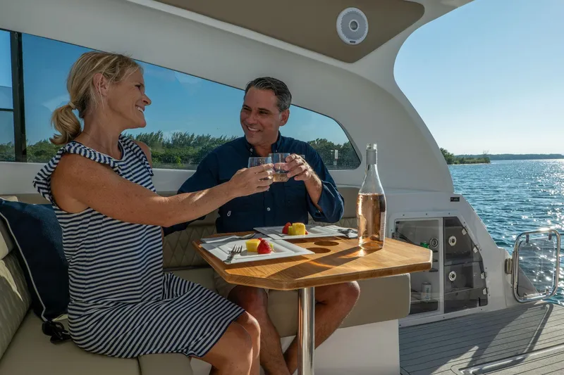 Slide: The Image of Couple enjoying a meal on a 2026 Hanover 375 yacht, with scenic ocean views. - 73