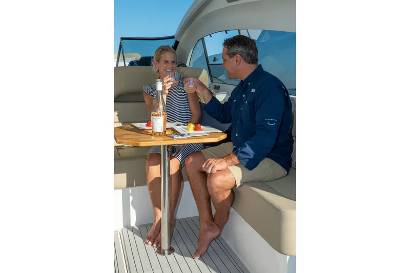 Slide: The Image of Couple enjoying drinks on Hanover 375 yacht, 2026 model, with a sunny backdrop. - 75