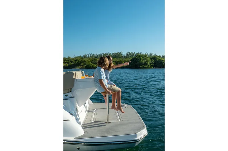 Slide: The Image of Couple enjoying a sunny day on a 2026 Hanover 375 boat, overlooking the water. - 78